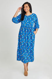 Model Terri-Leigh wearing size 14 of the Alice Gathered Dress in colour Speckle (Blue), from the front, showing the whole outfit