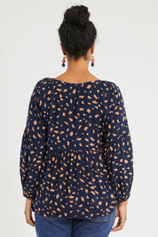 Model Noli wearing size 14 of the Dianna Blouse in colour Spot (Blue), from the back