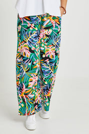 Model Terri-Leigh wearing size 14 of the Stella Print Pant in colour Rainforest (Blue), from the front, cropped image