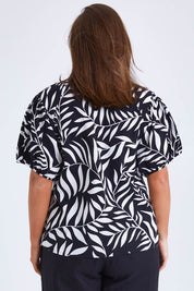 Model Monique wearing size 14 of the Rachel Bell Sleeve Top in colour Vines (Black), from the back