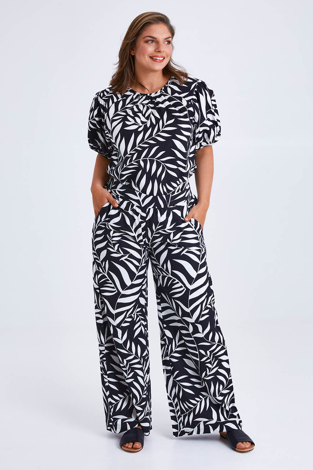 Model Monique wearing size 14 of the Rachel Bell Sleeve Top in colour Vines (Black), from the front, showing the whole outfit