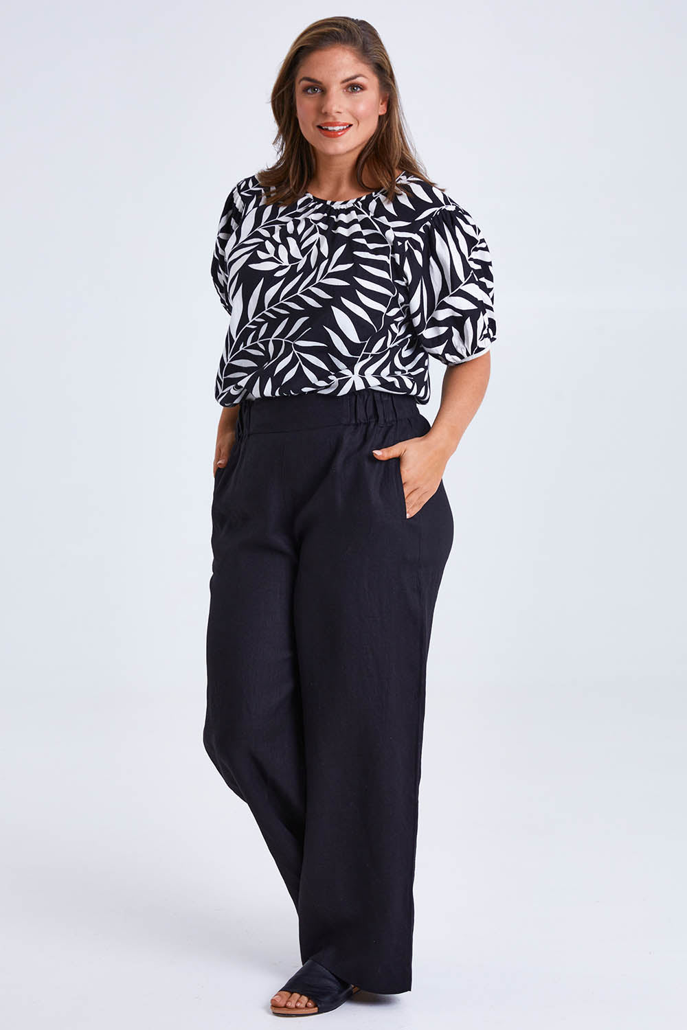 Model Monique wearing size 14 of the Rachel Bell Sleeve Top in colour Vines (Black), from the front, showing the whole outfit