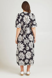 Model Jane wearing size 14 of the Gloria Cotton Wrap Dress in colour Bolddaisy (Black), from the back