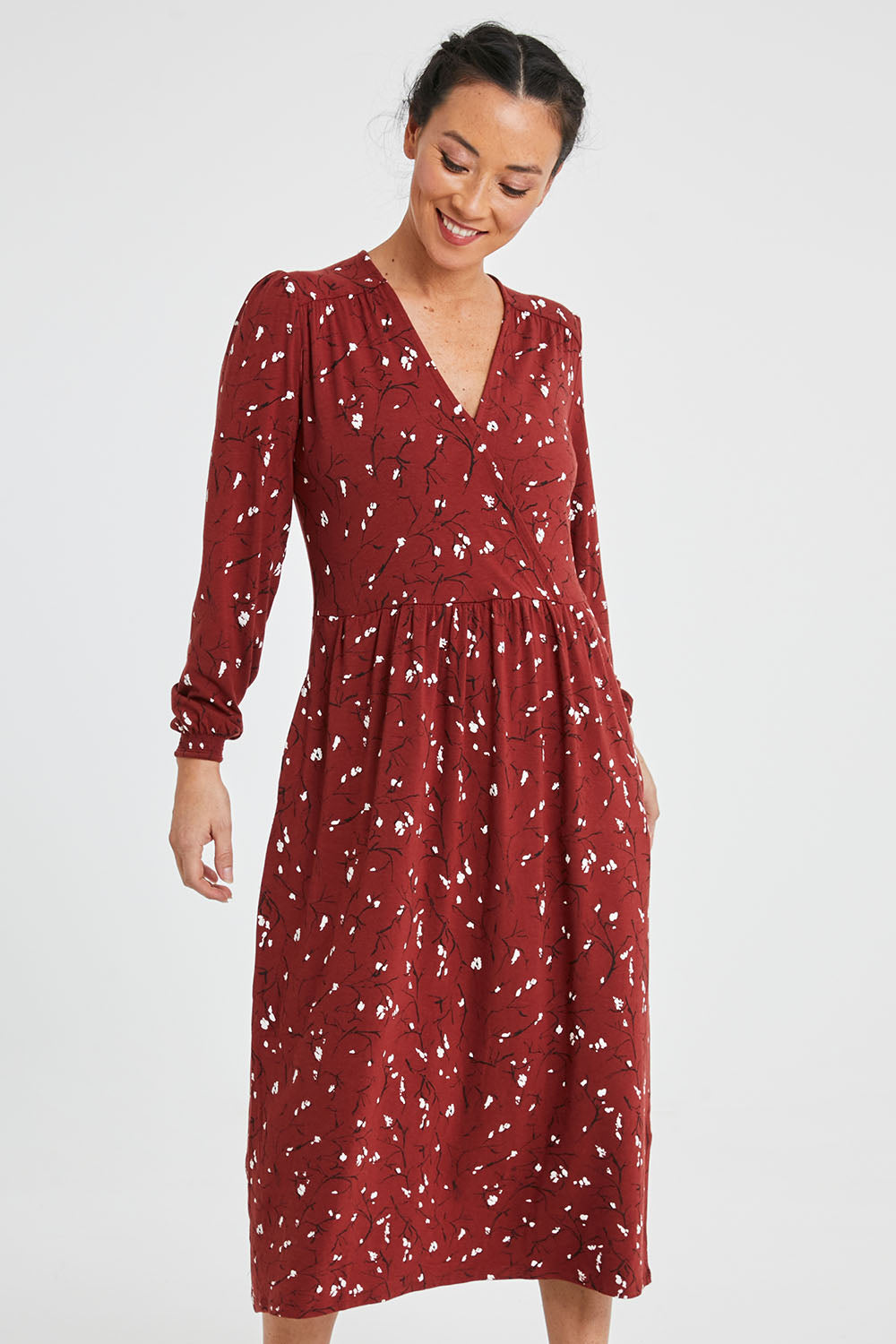 Model Katie wearing size 10 of the Eria Bamboo Wrap Dress in colour Oranrust (Red), from the front, cropped image