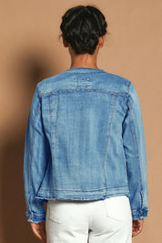 Model Katie wearing size S of the Collarless Jacket in colour Denim (Blue), from the back