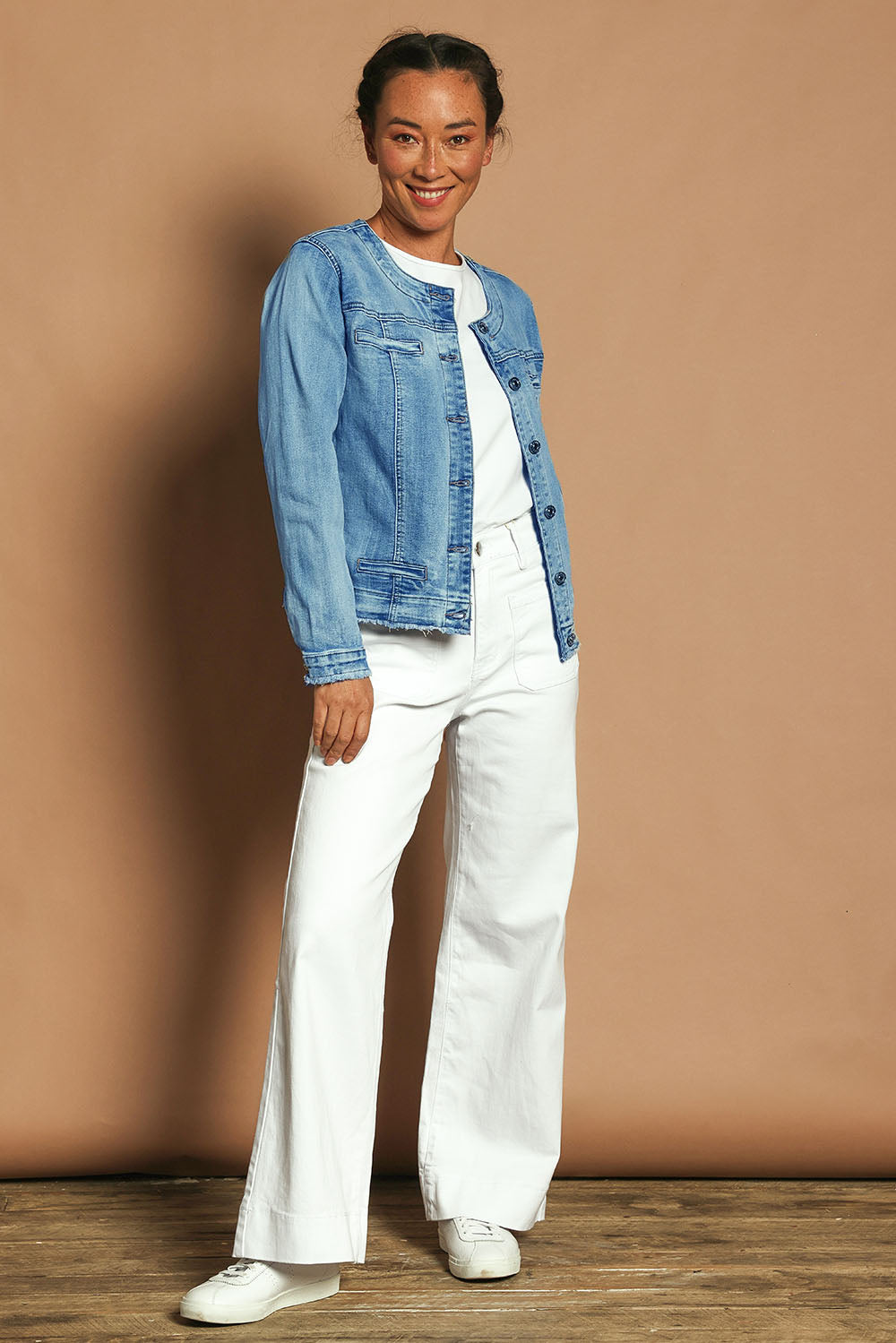 Model Katie wearing size S of the Collarless Jacket in colour Denim (Blue), from the front, showing the whole outfit