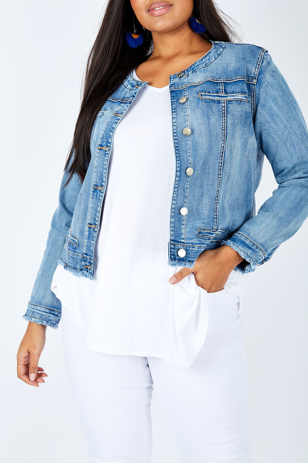 Model Shanaya wearing size L of the Collarless Jacket in colour Denim (Blue), from the front, cropped image