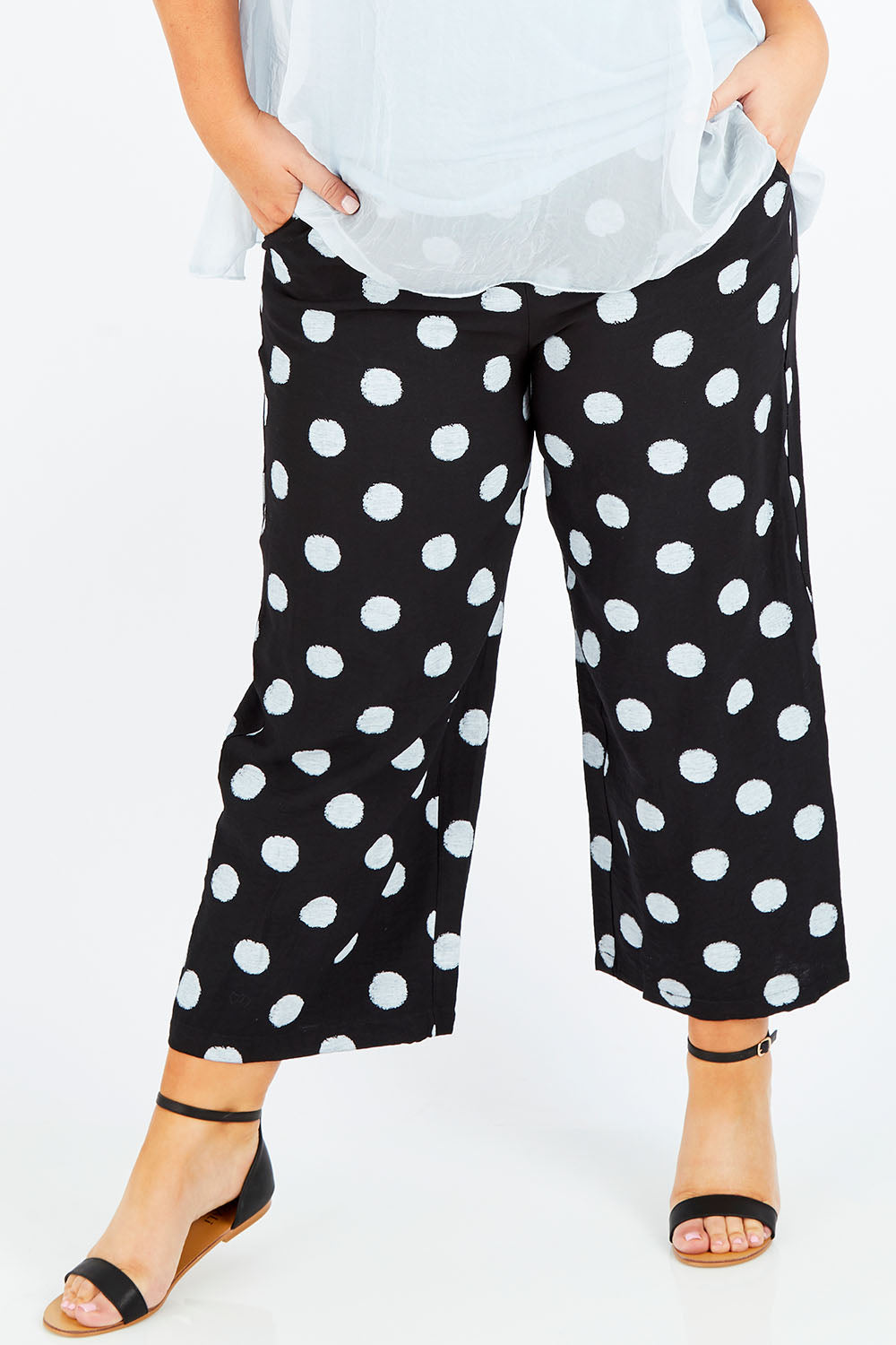 Model Stacey wearing size XL of the Spot Pant in colour BlackWhite (Black), from the front, cropped image
