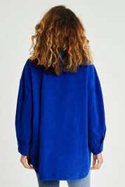 Model Emma wearing size S of the Zoe Cord Shacket in colour Cobalt (Blue), from the back