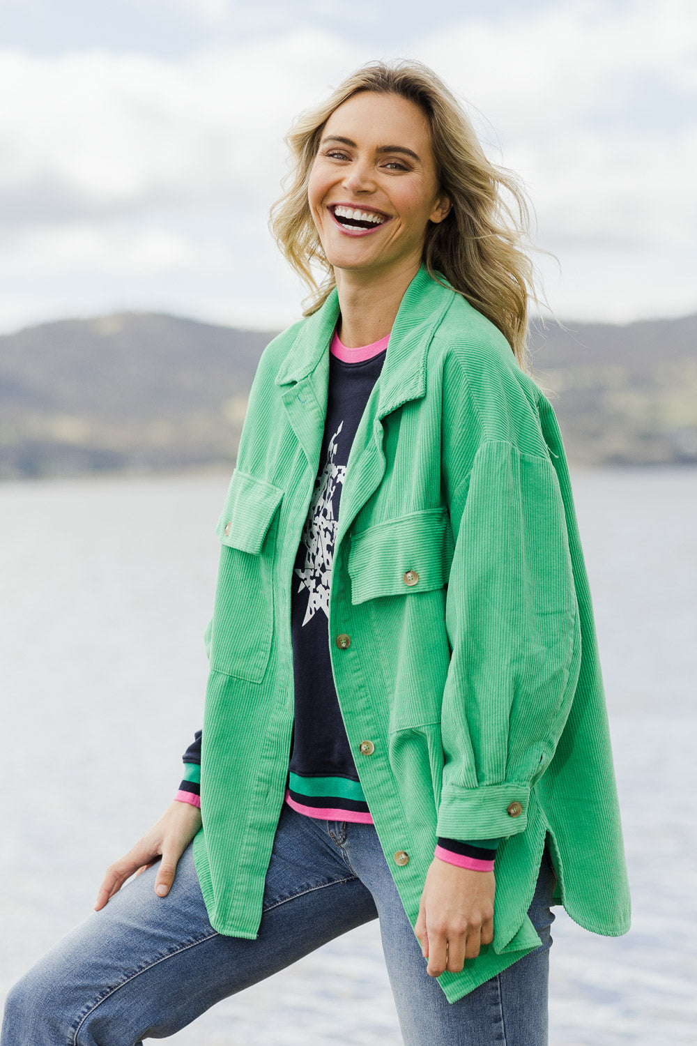 Model Alice wearing size S of the Zoe Cord Shacket in colour Jade (Green), from the front, showing the whole outfit