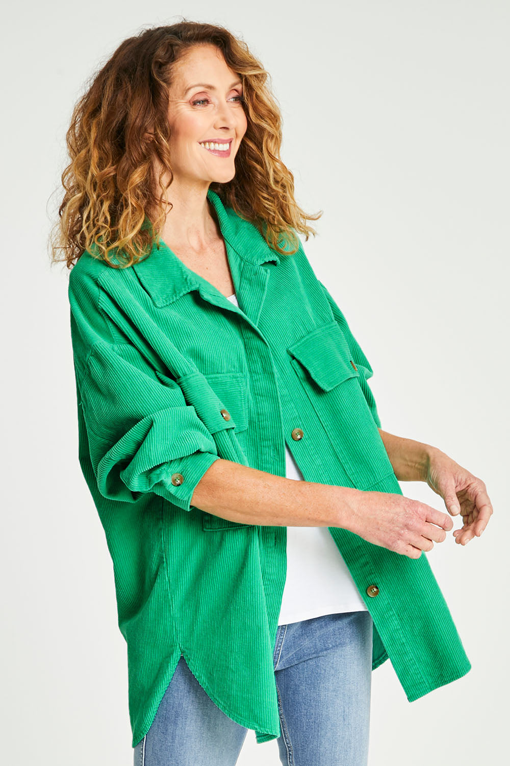 Model Emma wearing size S of the Zoe Cord Shacket in colour Jade (Green), from the front, cropped image