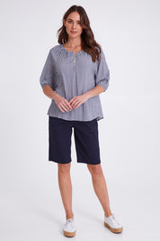 Model Madeline wearing size S of the Check It Out Top in colour Navy (Blue), from the front, showing the whole outfit