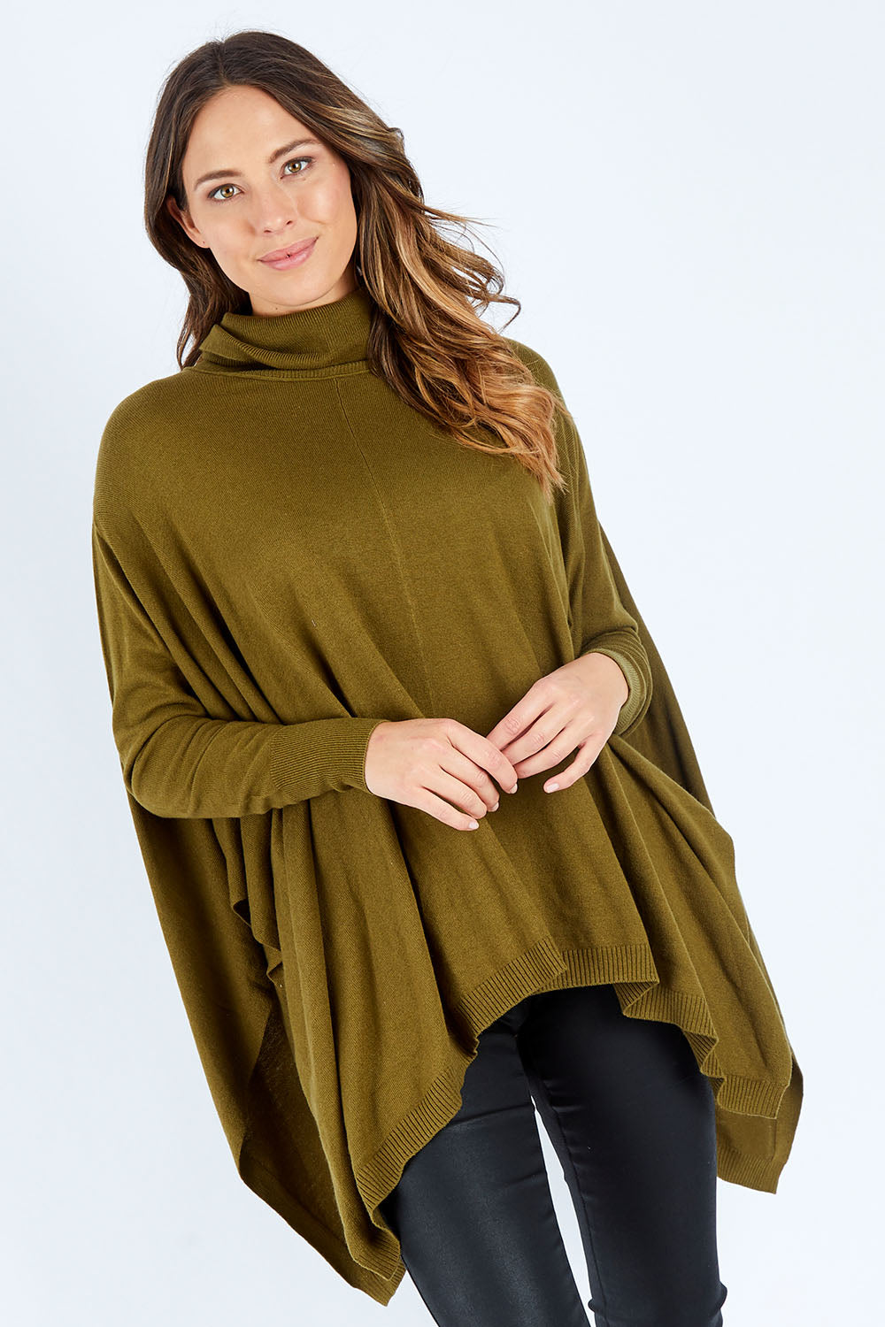 Model Madeline wearing size S of the Poncho Pullover in colour Moss (Green), from the front, cropped image