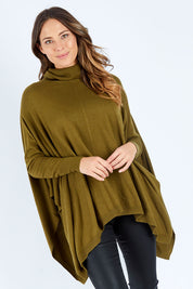Model Madeline wearing size S of the Poncho Pullover in colour Moss (Green), from the front, cropped image