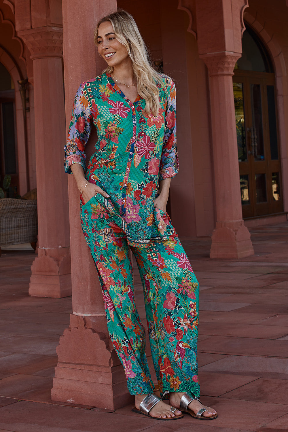 A model wearing the Eastern Pant in colour Emerald (Green), from the front, showing the whole outfit
