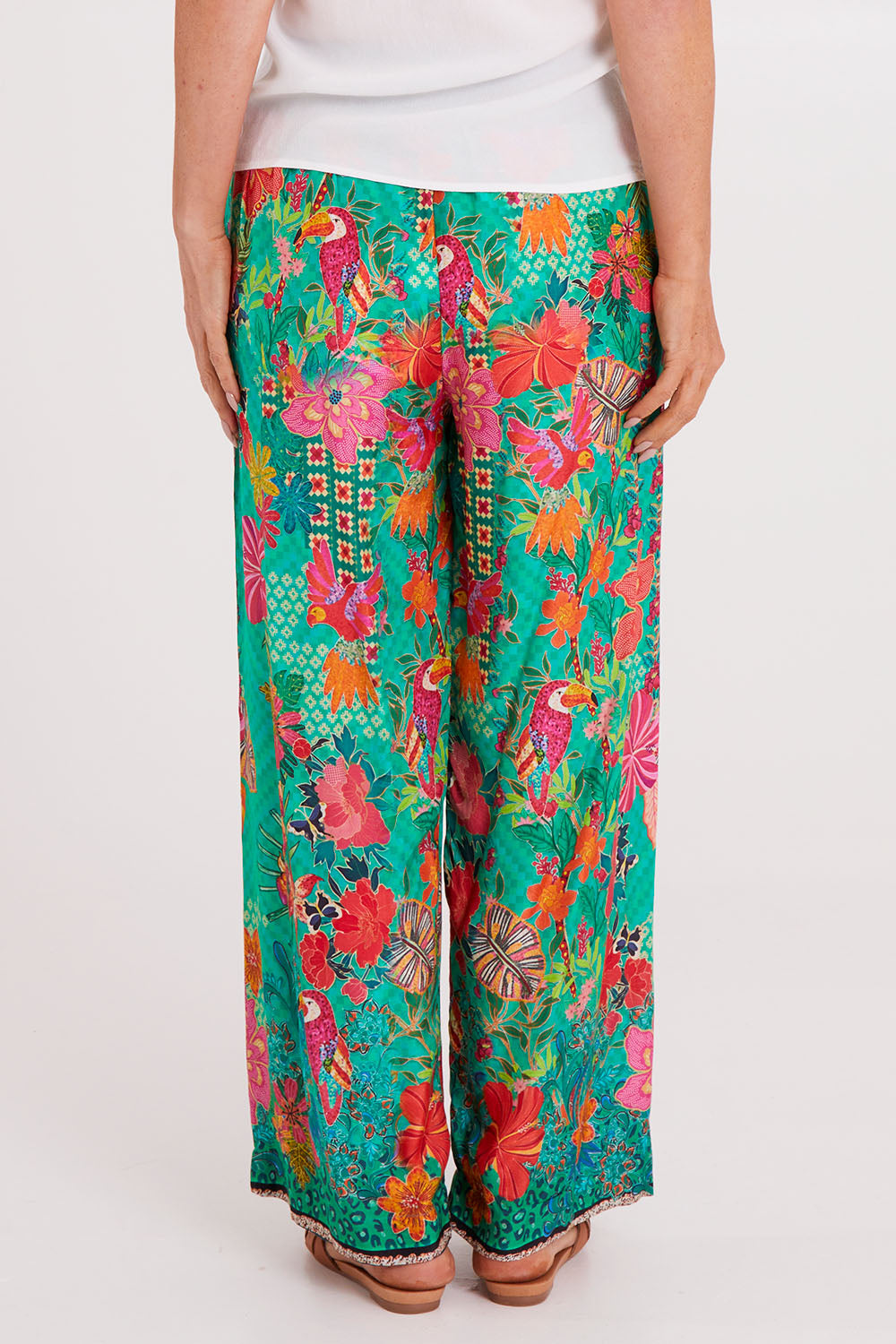 Model Luisa wearing size S of the Eastern Pant in colour Emerald (Green), from the back