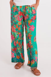 Model Luisa wearing size S of the Eastern Pant in colour Emerald (Green), from the front, cropped image