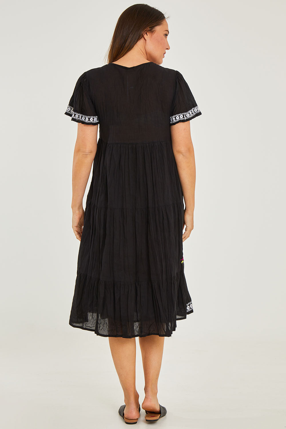 Model Georgia wearing size S of the Zeta Dress in colour Black (Black), from the back