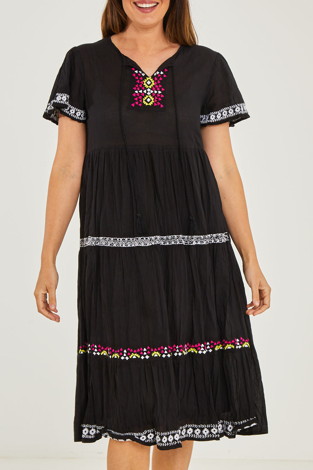 Model Georgia wearing size S of the Zeta Dress in colour Black (Black), from the front, cropped image