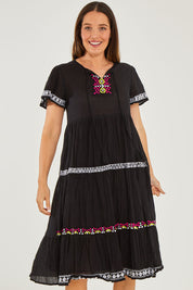 Model Georgia wearing size S of the Zeta Dress in colour Black (Black), from the front, cropped image
