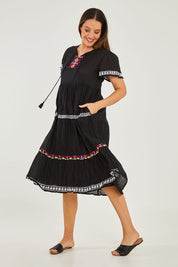 Model Georgia wearing size S of the Zeta Dress in colour Black (Black), from the front, showing the whole outfit
