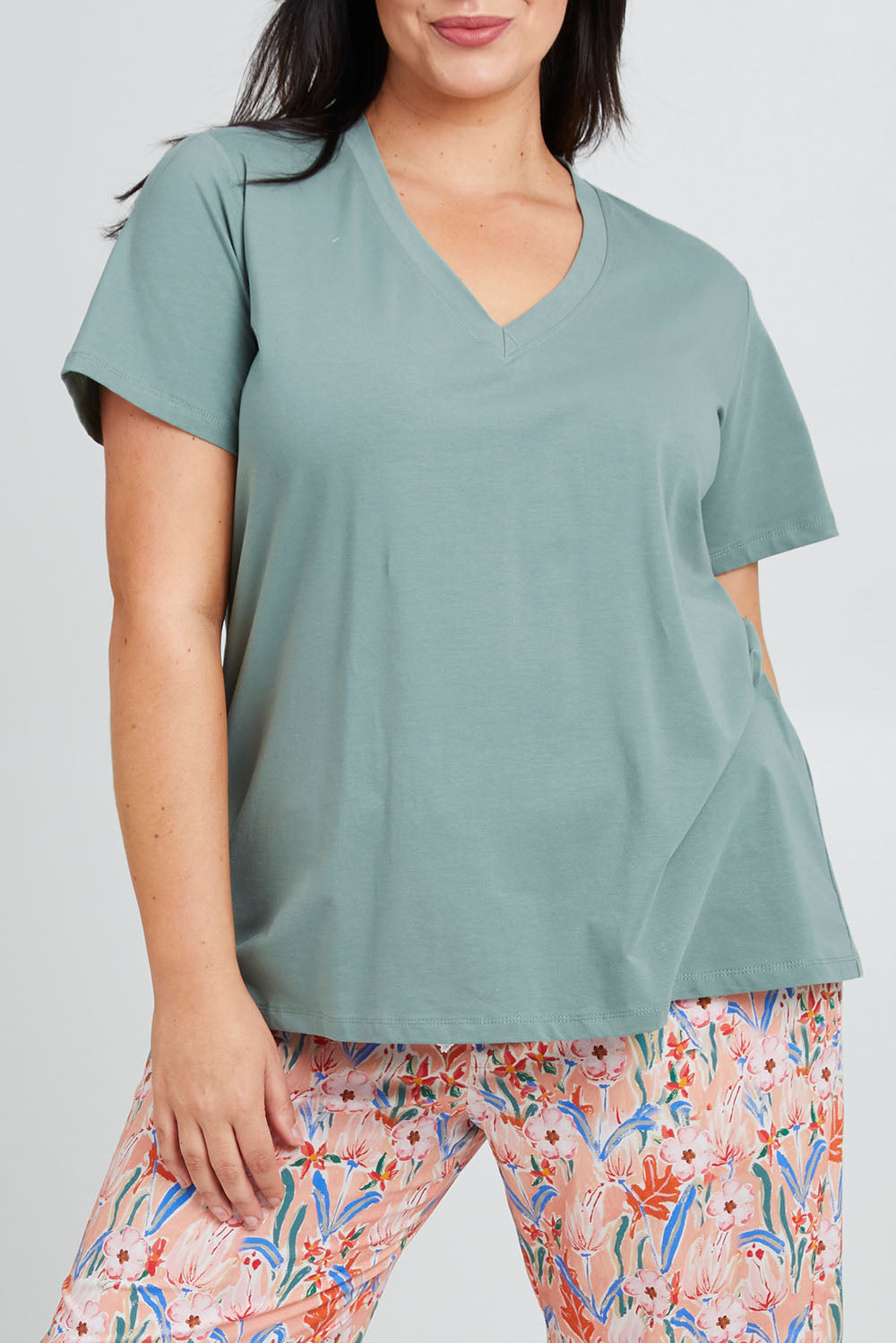 Model Poppy wearing the Cotton Jersey V Neck Tee in colour Sage (Green), from the front, cropped image
