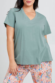 Model Poppy wearing the Cotton Jersey V Neck Tee in colour Sage (Green), from the front, cropped image