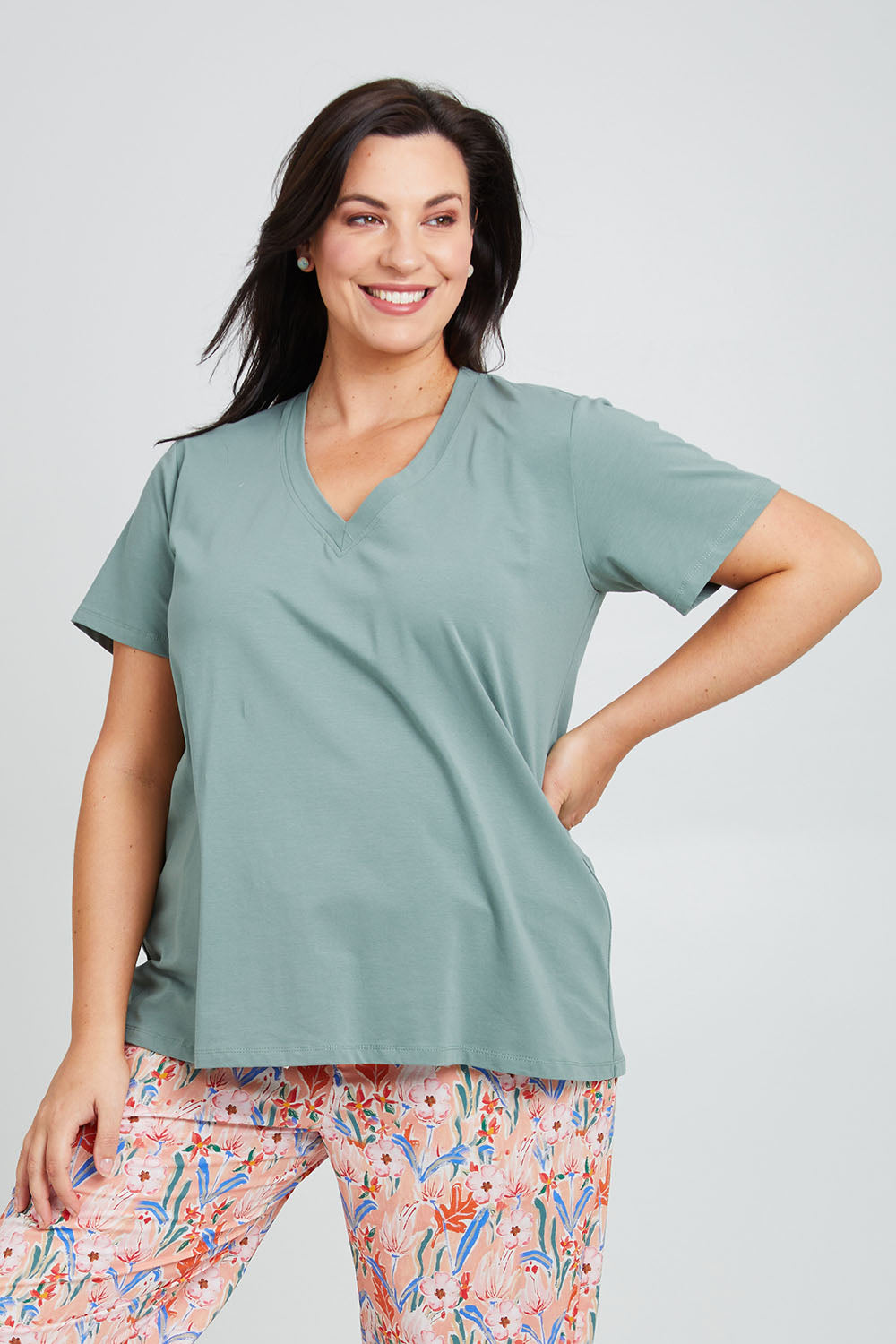 Model Poppy wearing the Cotton Jersey V Neck Tee in colour Sage (Green), from the front, cropped image