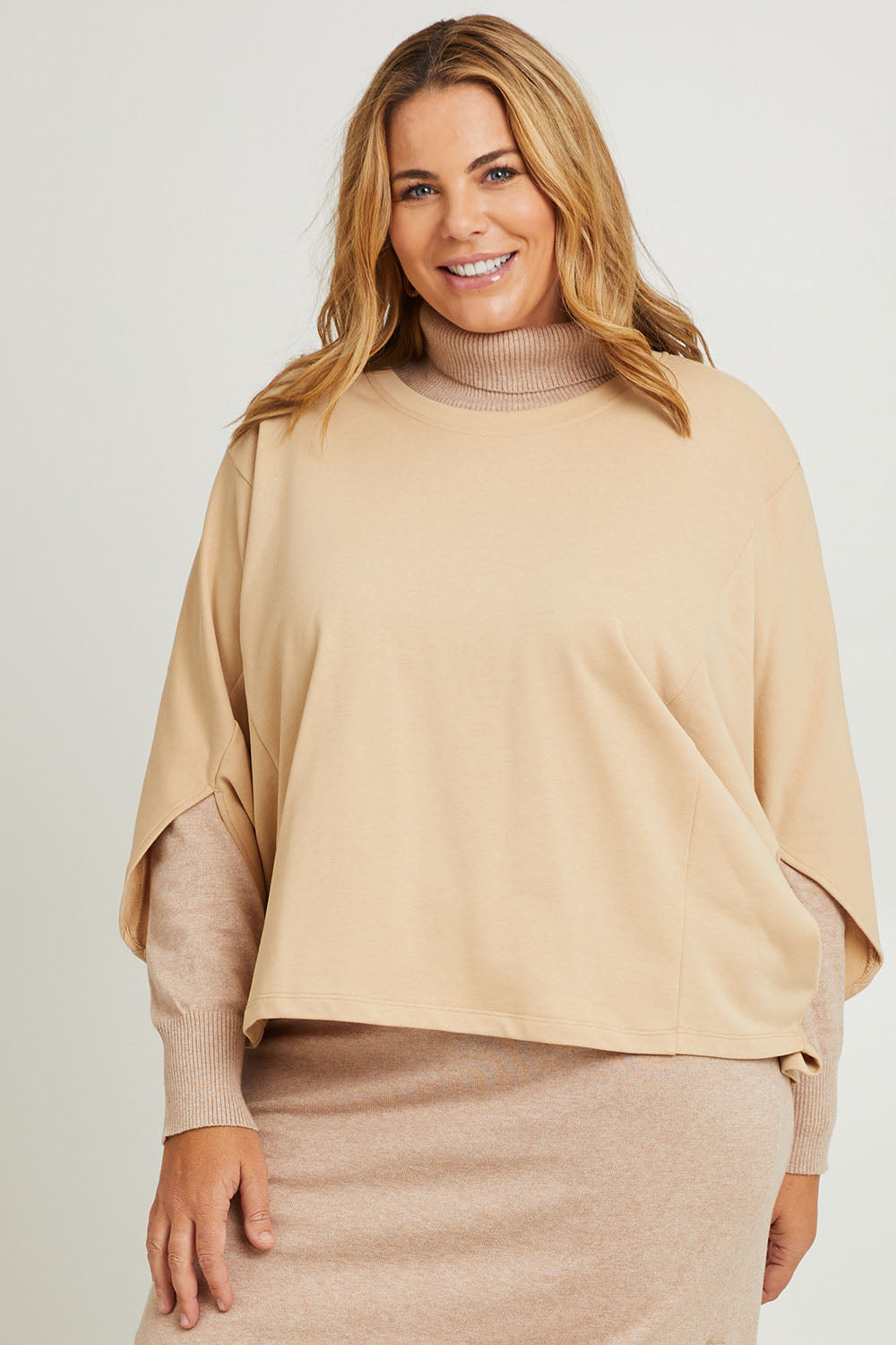Model Fiona wearing the Cotton Terry Batwing Sweater in colour Porridge, from the front, cropped image