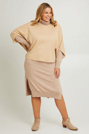 Model Fiona wearing the Cotton Terry Batwing Sweater in colour Porridge, from the front, showing the whole outfit