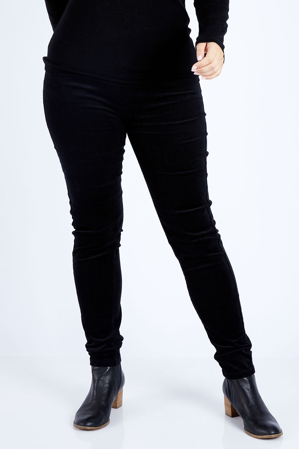 Model Jess wearing size 14 of the Skinny Leg Cord Pull On Pant in colour Black (Black), from the front, cropped image