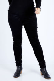 Model Jess wearing size 14 of the Skinny Leg Cord Pull On Pant in colour Black (Black), from the front, cropped image