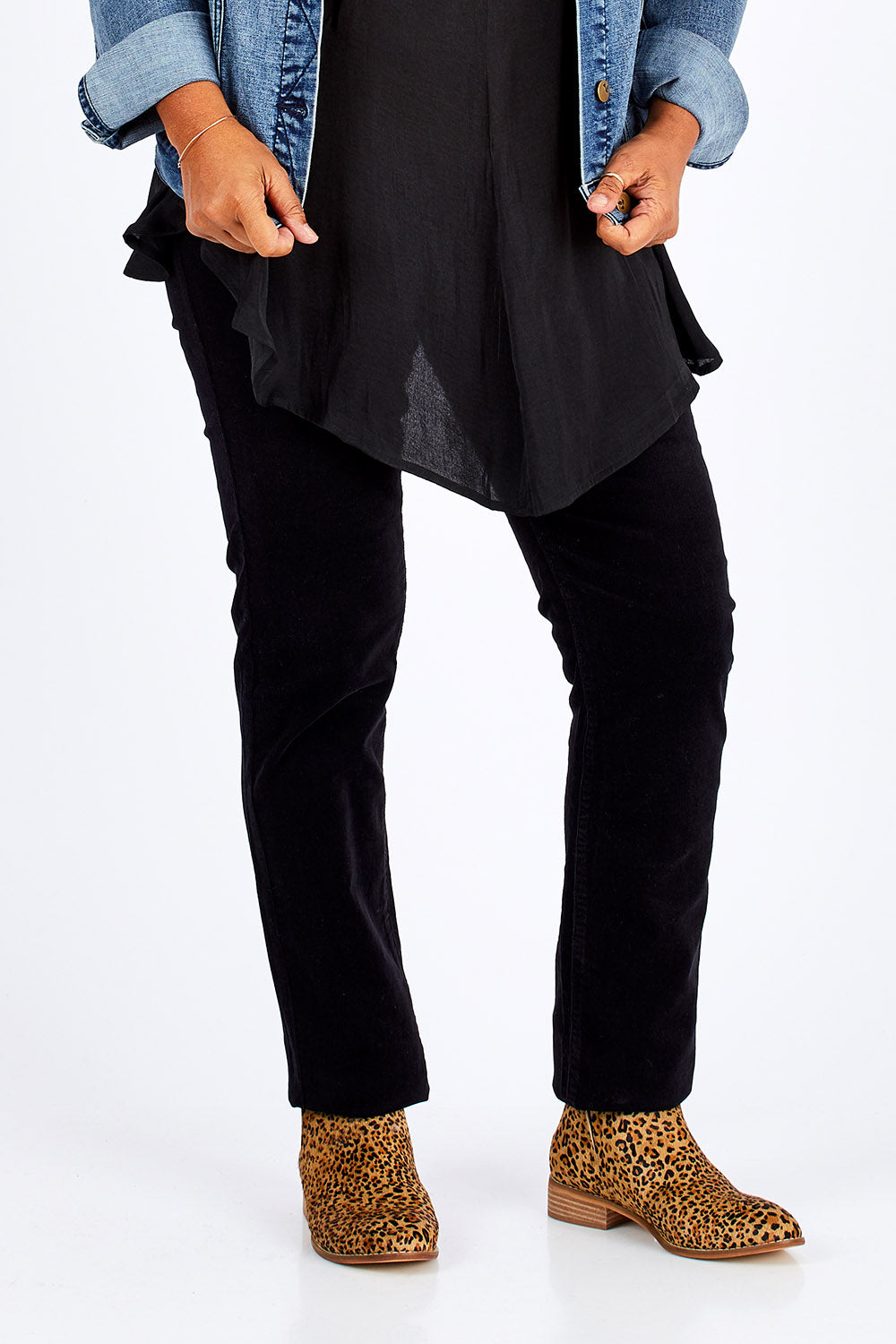 Model Nadine wearing size 10 of the Skinny Leg Cord Pull On Pant in colour Black (Black), from the front, cropped image