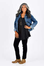 Model Nadine wearing size 10 of the Skinny Leg Cord Pull On Pant in colour Black (Black), from the front, showing the whole outfit