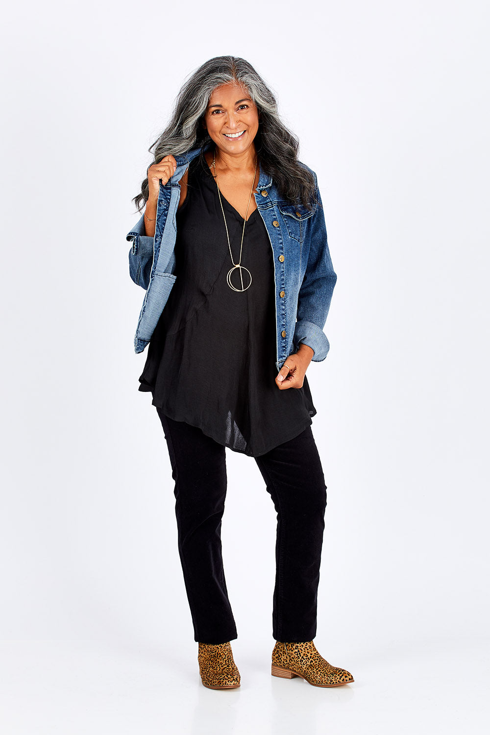 Model Nadine wearing size 10 of the Skinny Leg Cord Pull On Pant in colour Black (Black), from the front, showing the whole outfit