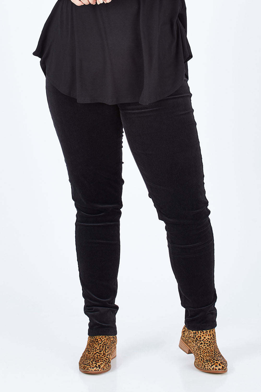 Model Sophie wearing size 14 of the Skinny Leg Cord Pull On Pant in colour Black (Black), from the front, cropped image