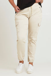 Model Chanel wearing size 16 of the Harlow Cargo Jogger in colour Beige, from the front, cropped image
