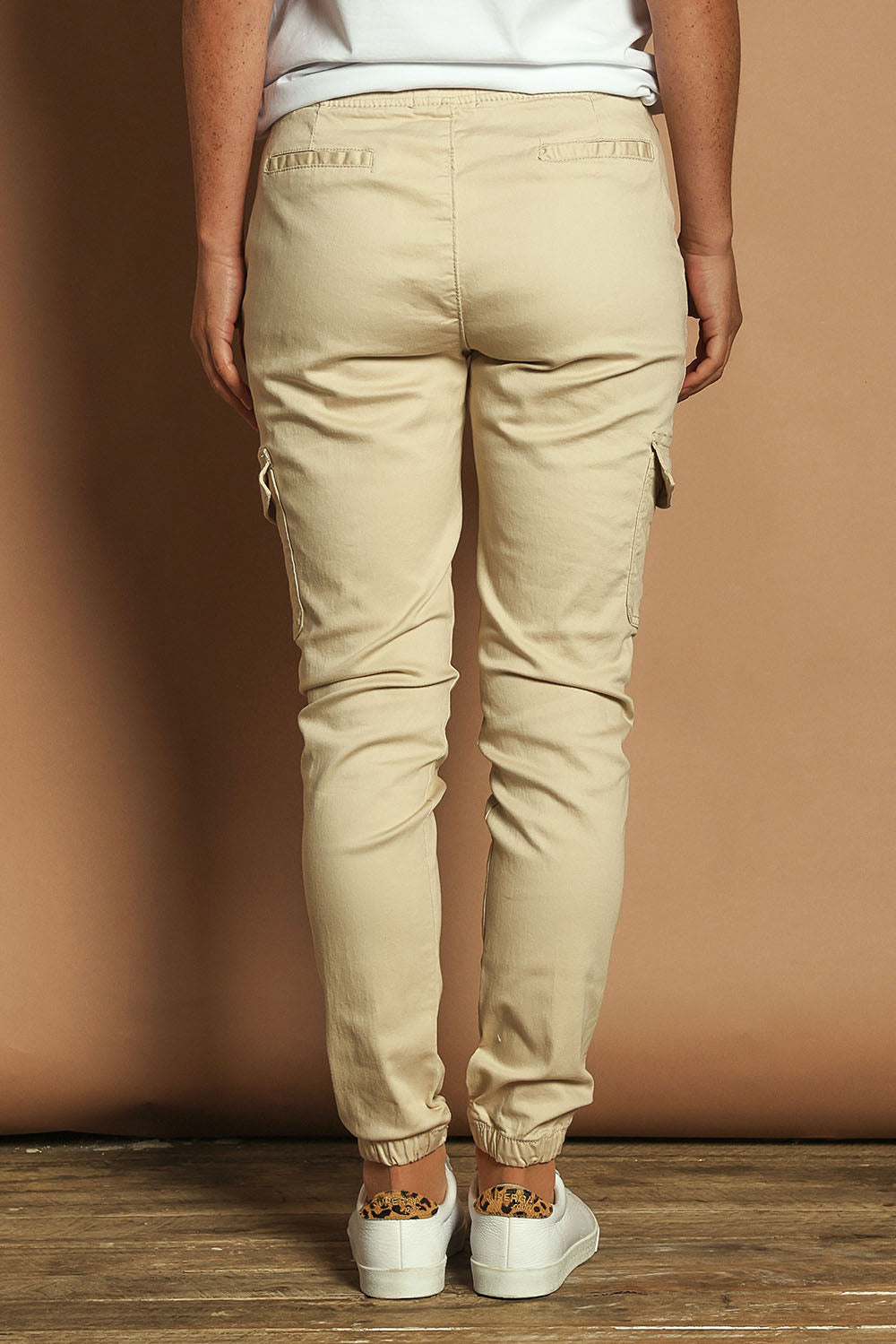 Model Katie wearing size 10 of the Harlow Cargo Jogger in colour Beige, from the back