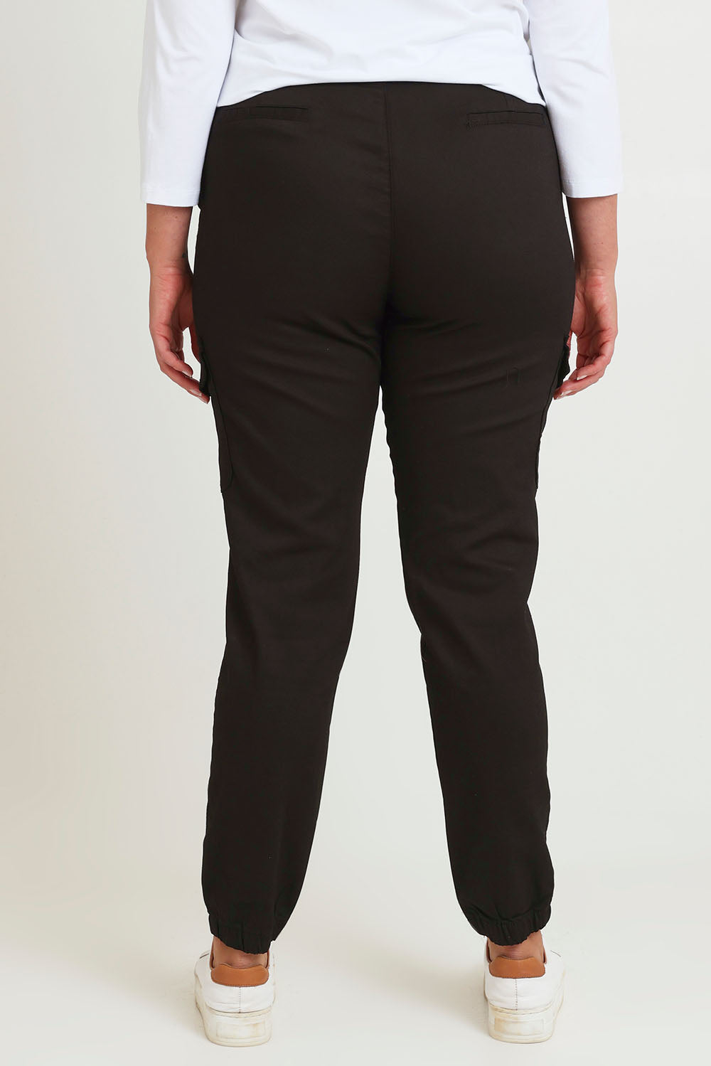 Model Chanel wearing size 16 of the Harlow Cargo Jogger in colour Black (Black), from the back