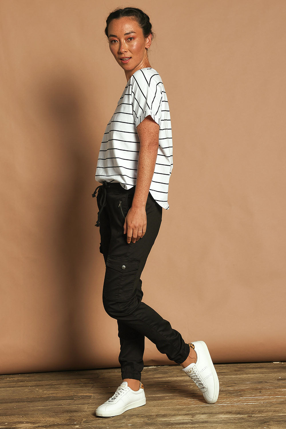 Model Katie wearing size 10 of the Harlow Cargo Jogger in colour Black (Black), from the front, showing the whole outfit