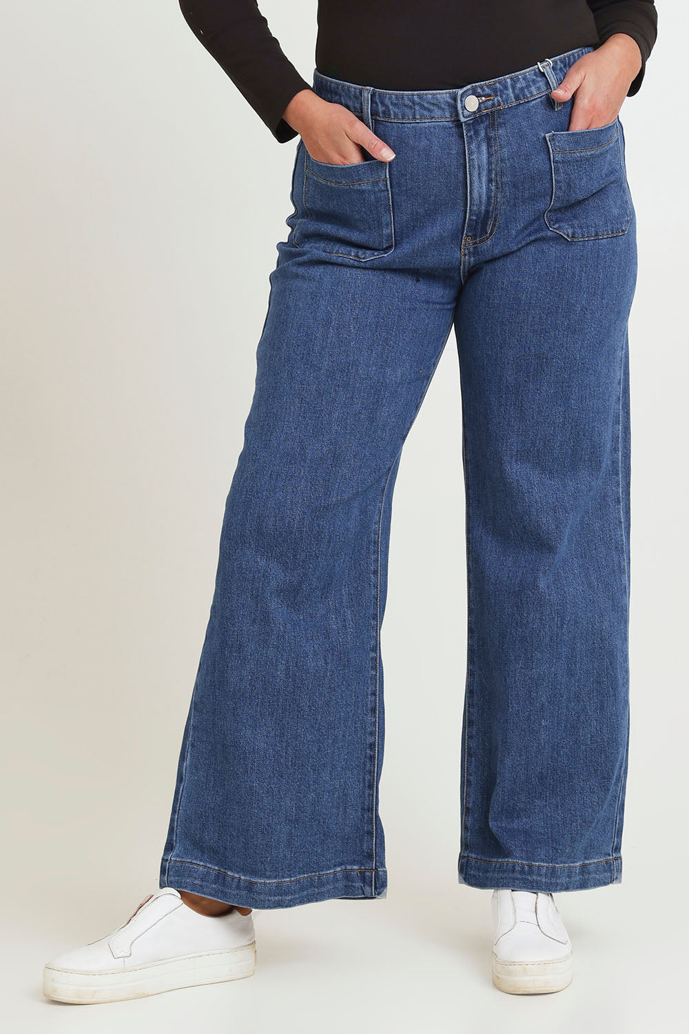 Model Chanel wearing size 16 of the Katie Highin colourWaisted Front Pocket Wide Leg Jean - Middenim (Blue), from the front, cropped image