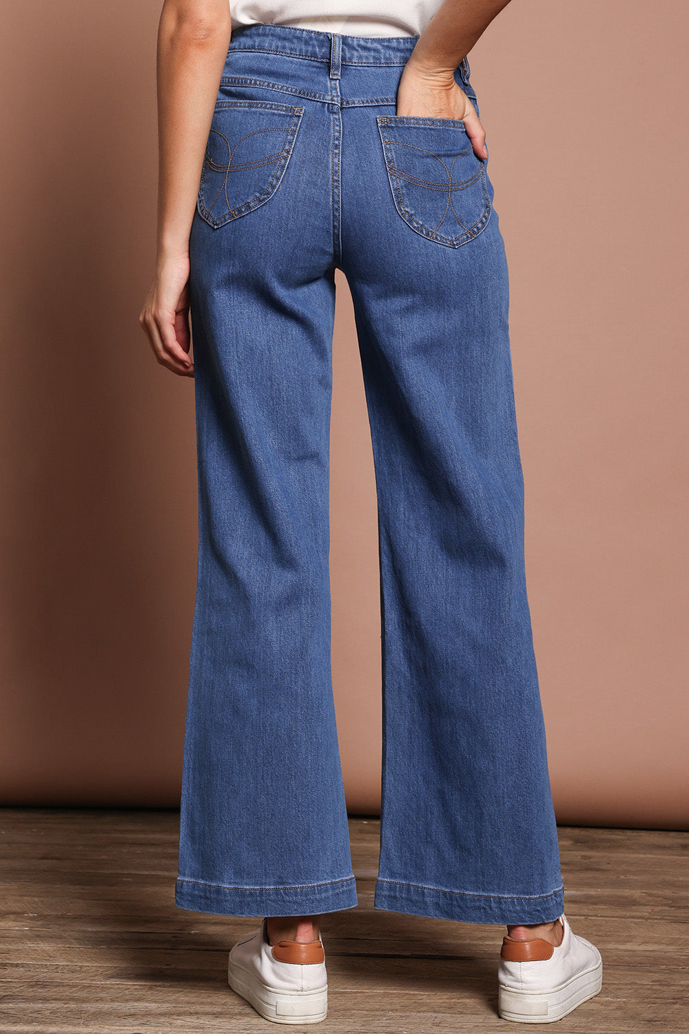 Model Madeline wearing size 9 of the Katie Highin colourWaisted Front Pocket Wide Leg Jean - Middenim (Blue), from the back