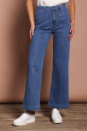 Model Madeline wearing size 9 of the Katie Highin colourWaisted Front Pocket Wide Leg Jean - Middenim (Blue), from the front, cropped image