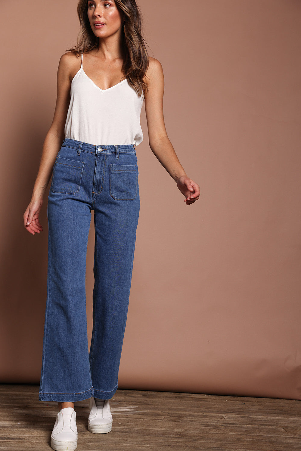 Model Madeline wearing size 9 of the Katie Highin colourWaisted Front Pocket Wide Leg Jean - Middenim (Blue), from the front, showing the whole outfit