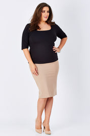 Model Mae wearing size 16 of The Ponte Knee Length Pencil Skirt in colour Beige, from the front, showing the whole outfit