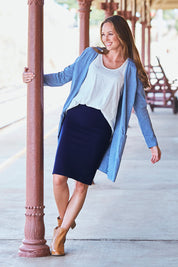 Model Emma wearing size 10 of The Ponte Knee Length Pencil Skirt in colour Navy (Blue), from the front, showing the whole outfit