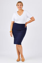 Model Ljubenka wearing size 18 of The Ponte Knee Length Pencil Skirt in colour Navy (Blue), from the front, showing the whole outfit