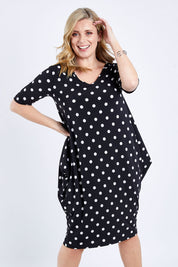 Model Brooke wearing size 10 of the Preloved Flowing V Neck Dress in colour Blkspot (Black), from the front, cropped image