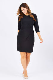 Model Laura wearing size 12 of the Side Cross Dress in colour Black (Black), from the front, showing the whole outfit