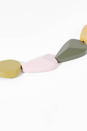 A model wearing size OneSize of the Koala Multi Necklace in colour Olive (Green), from the front, showing the whole outfit